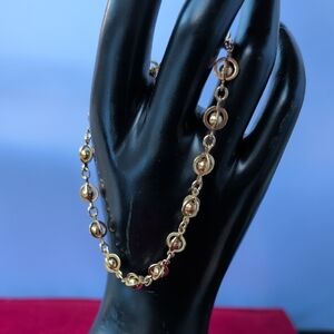 vintage Avon Bracelet features a distinctive orb and link design, Gold Tone.